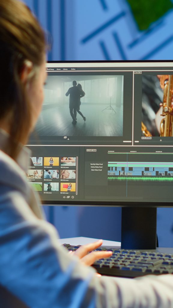 Video editor working at night at new project editing audio film montage